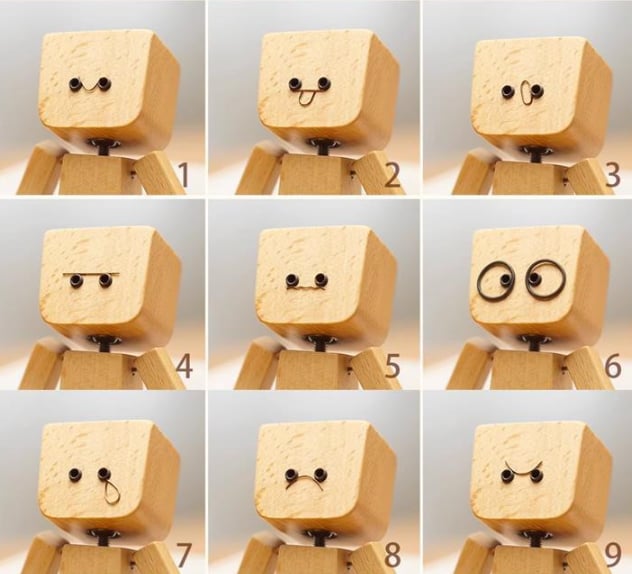 Charmig liten träfigur som svajar med 12 magnetiska uttryck