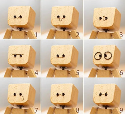 Charmig liten träfigur som svajar med 12 magnetiska uttryck